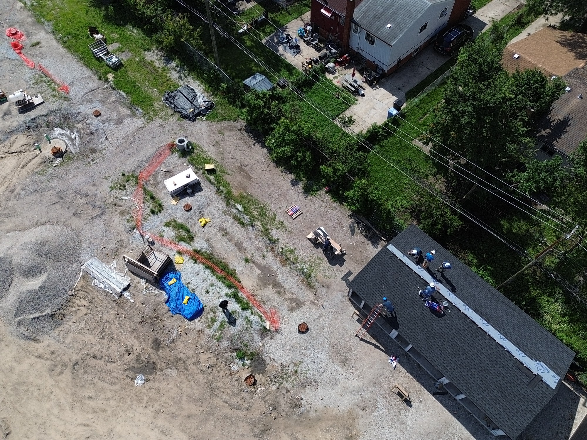 Aerial construction site with roofing crew