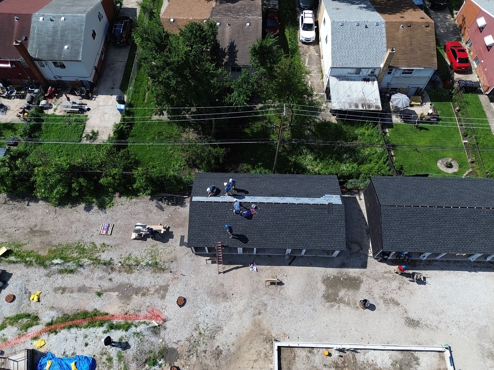 Aerial roofing crew working on residential property