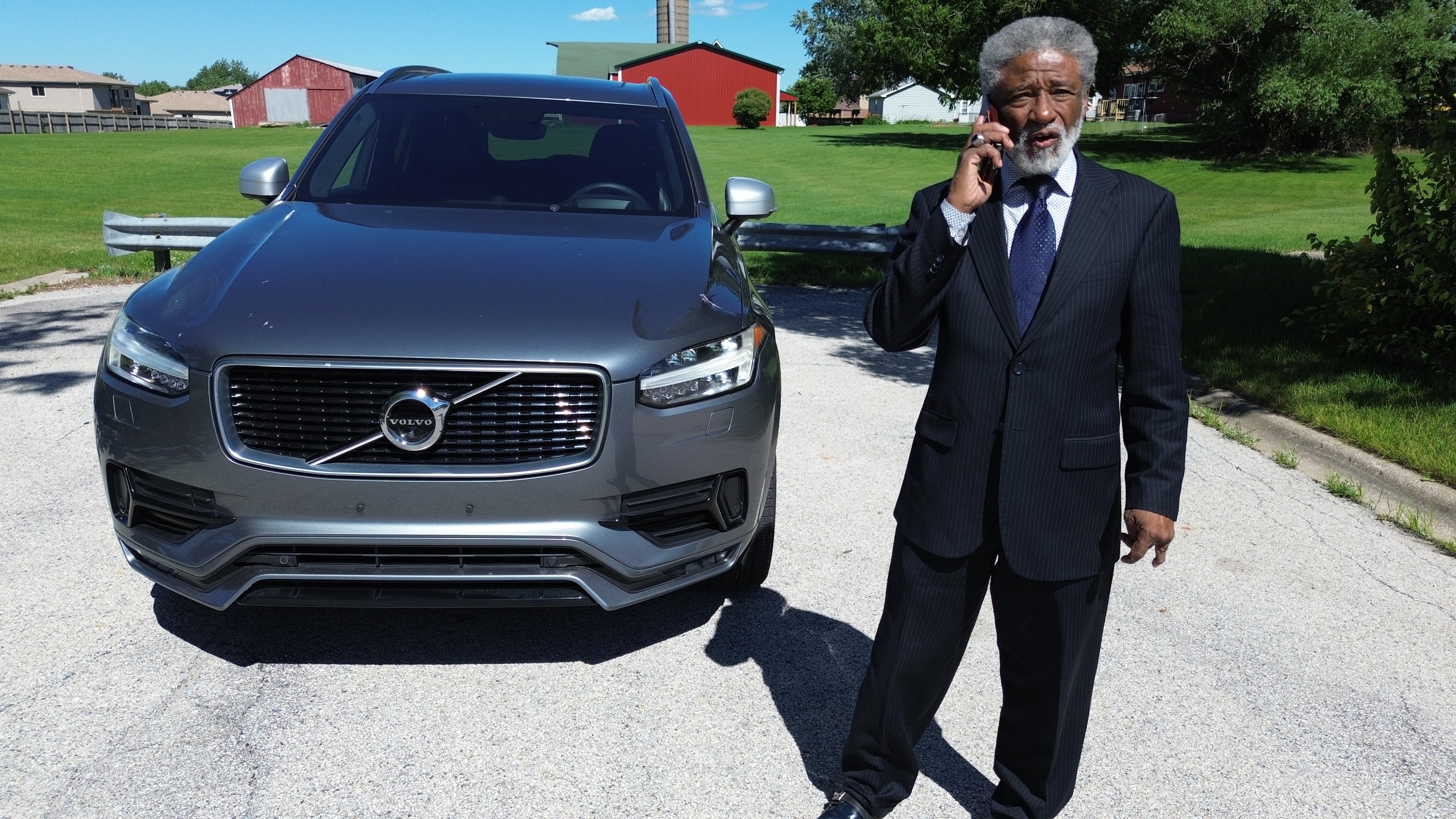Real estate agent with Volvo at property